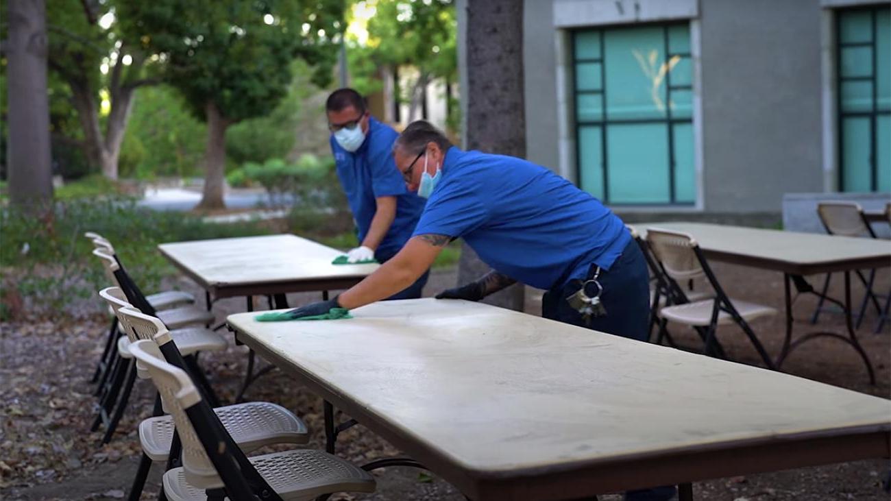 Staff cleaning tables