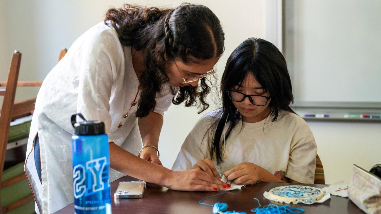 Current PAYS Scholar Abby Tran '25 learning how to stitch from PAYS Alumna Sarabjit Dhillon '22 in her elective class.