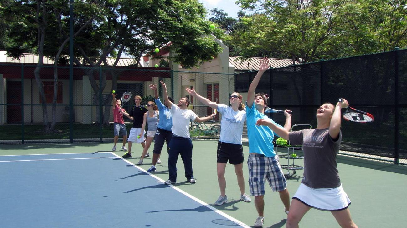 Beginning Tennis class practices their serves